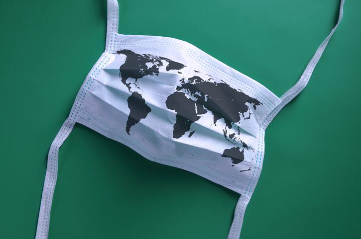 Coronavirus face mask with world map on green background
